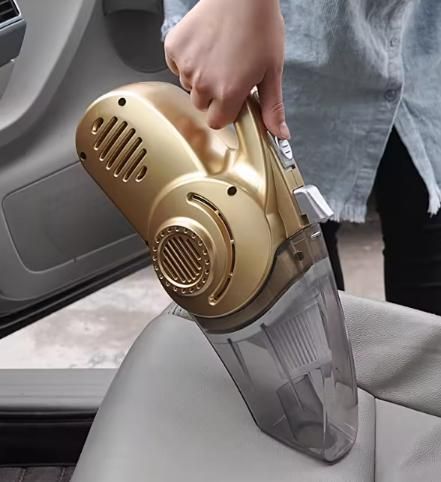 “Gold 4-in-1 car vacuum cleaner with high power suction, tyre inflator, pressure gauge and LED light on a dark background.”